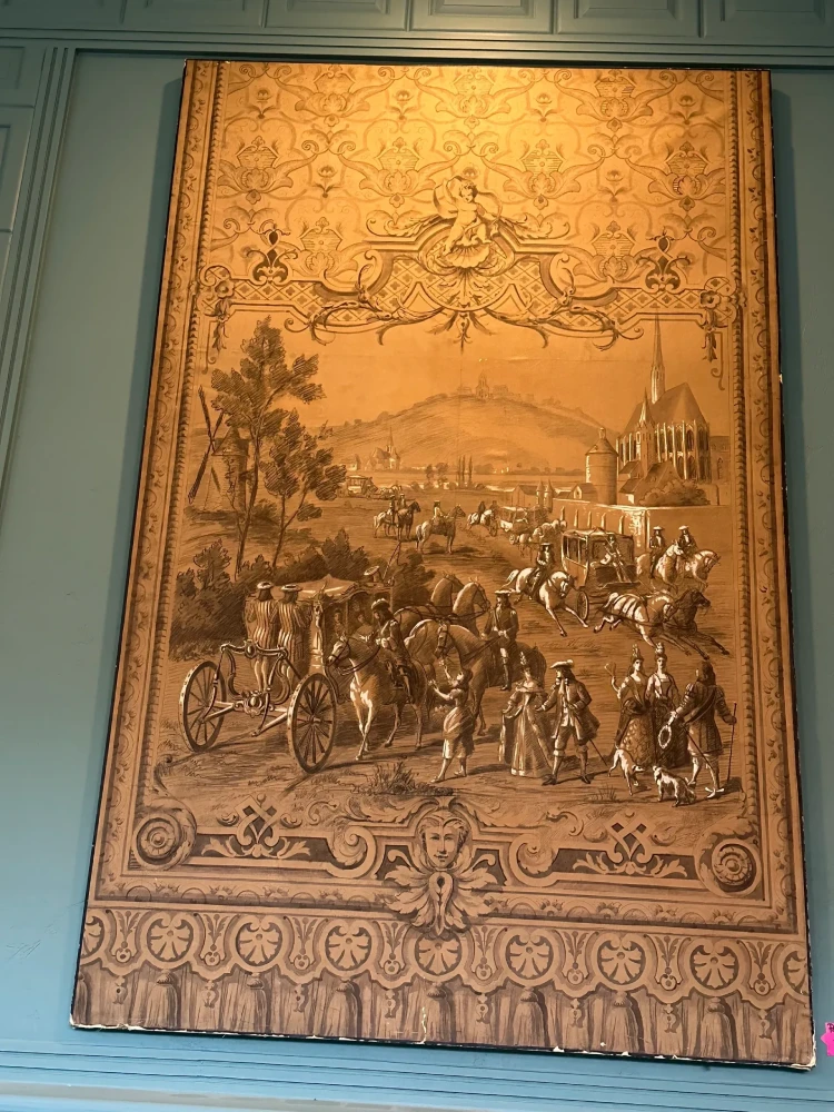 Large rectangular carved panel depicting a detailed historical gathering with figures, horses, trees, and decorative borders.