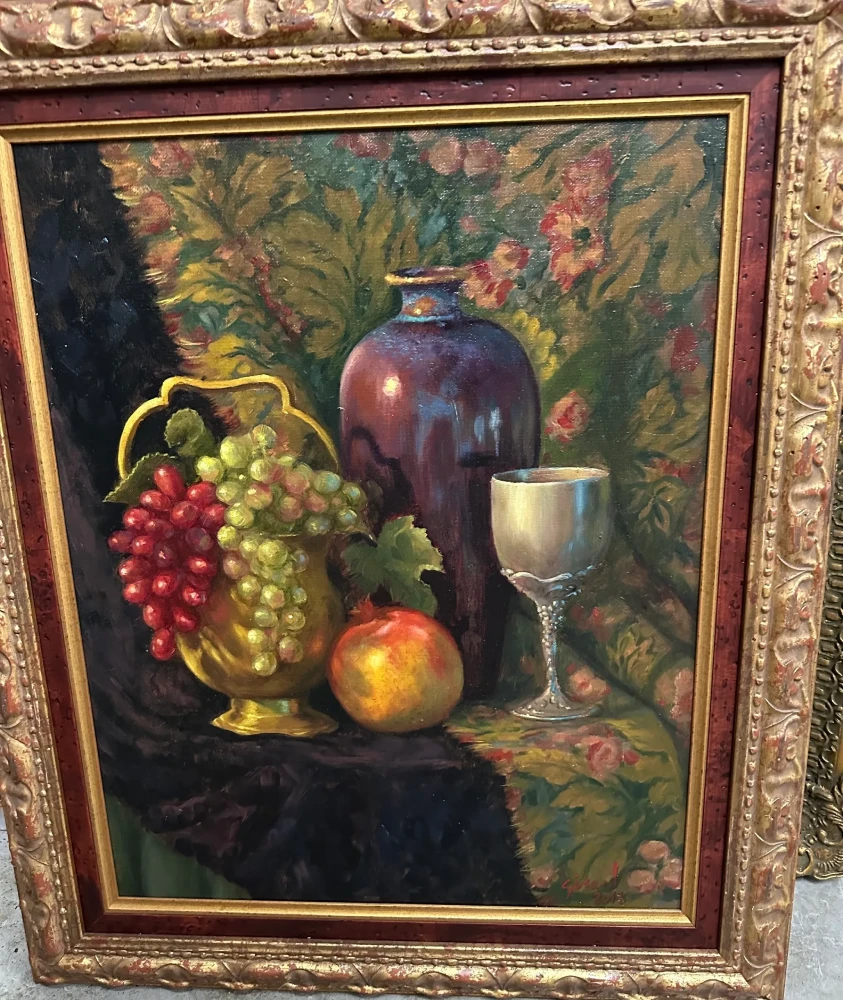 Richly colored still life featuring grapes, fruit, a wine glass, and a decorative vessel.