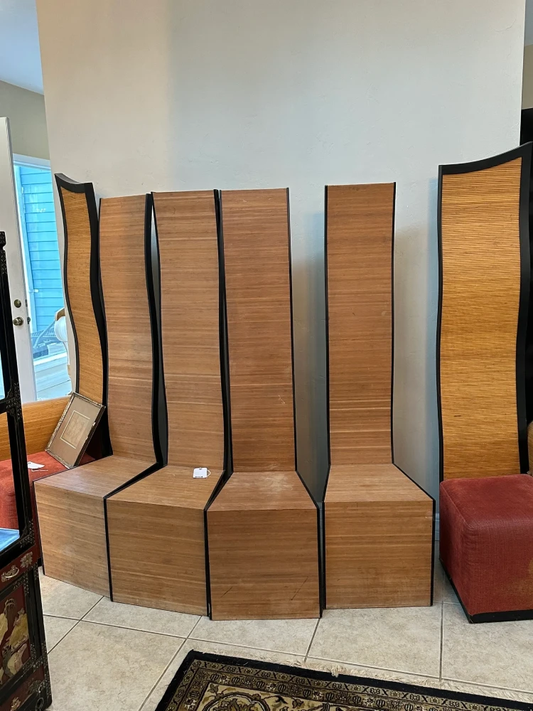 Coordinated set of tall high-back chairs featuring linear wood frames and woven or caned panel inserts.